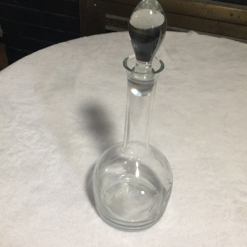 Floral etched glass decanter with stopper.